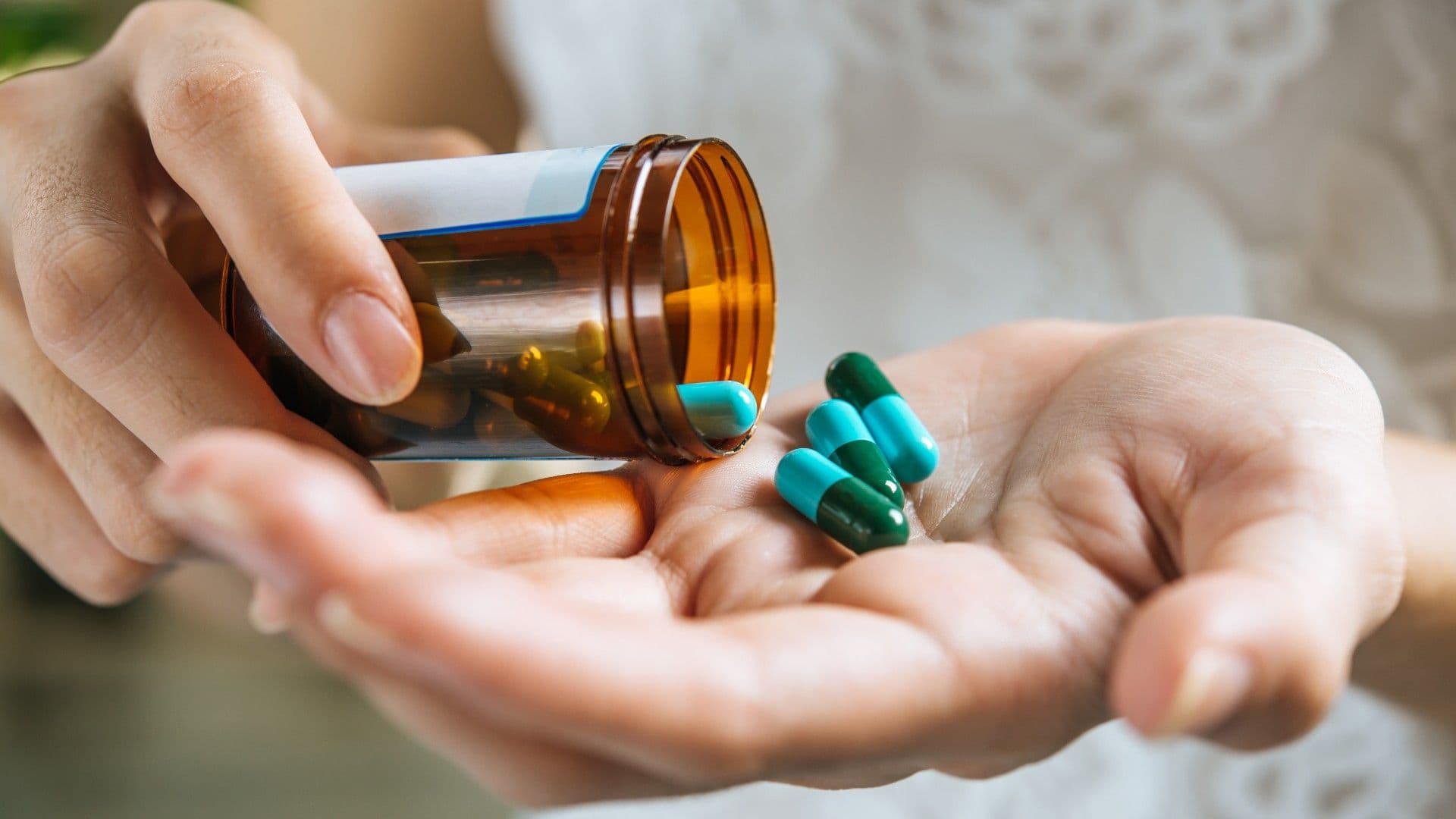 photologuephotos2023-07mano-mujer-vierte-pastillas-medicina-fuera-botella_1jpg