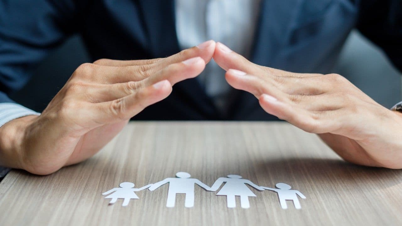 photologuephotos2024-11usinessman-hands-cover-family-paper-healthcare-insurance-concept_1jpg