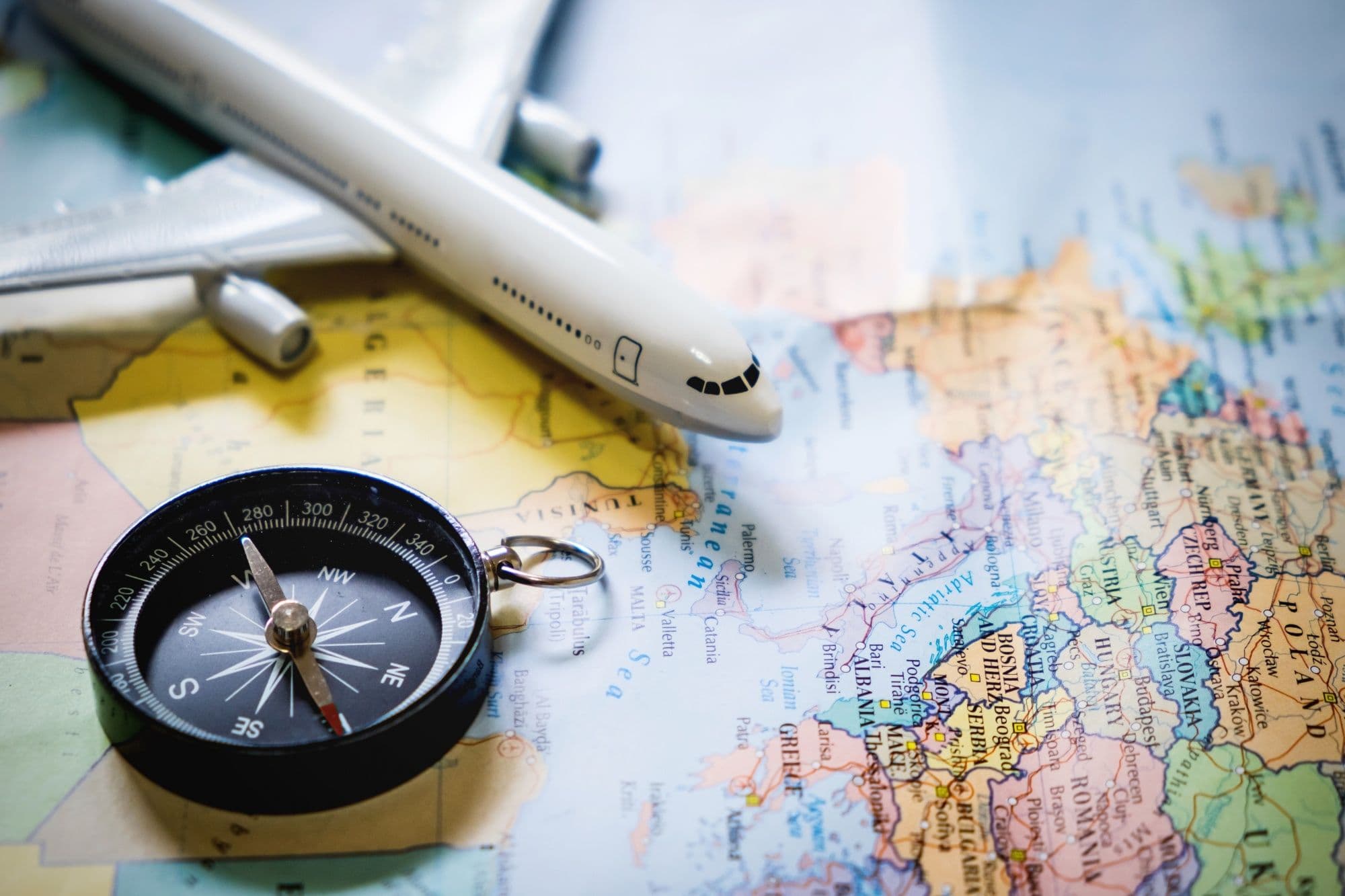 photologuephotos2022-10selective-focus-of-miniature-tourist-on-compass-over-map-with-plastic-toy-airplane-abstract-background-to-travel-conceptjpg photologuephotos2022-10selective-focus-of-miniature-tourist-on-compass-over-map-with-plastic-toy-airplane-abstract-background-to-travel-conceptjpg