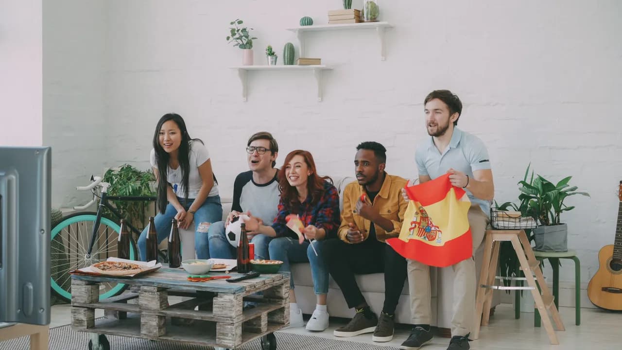 photologuephotos2022-10multiethnic-group-of-friends-sports-fans-with-spanish-flags-watching-football-championship-on-tv-together-at-home-and-cheering-up-favourite-teamjpg photologuephotos2022-10multiethnic-group-of-friends-sports-fans-with-spanish-flags-watching-football-championship-on-tv-together-at-home-and-cheering-up-favourite-teamjpg