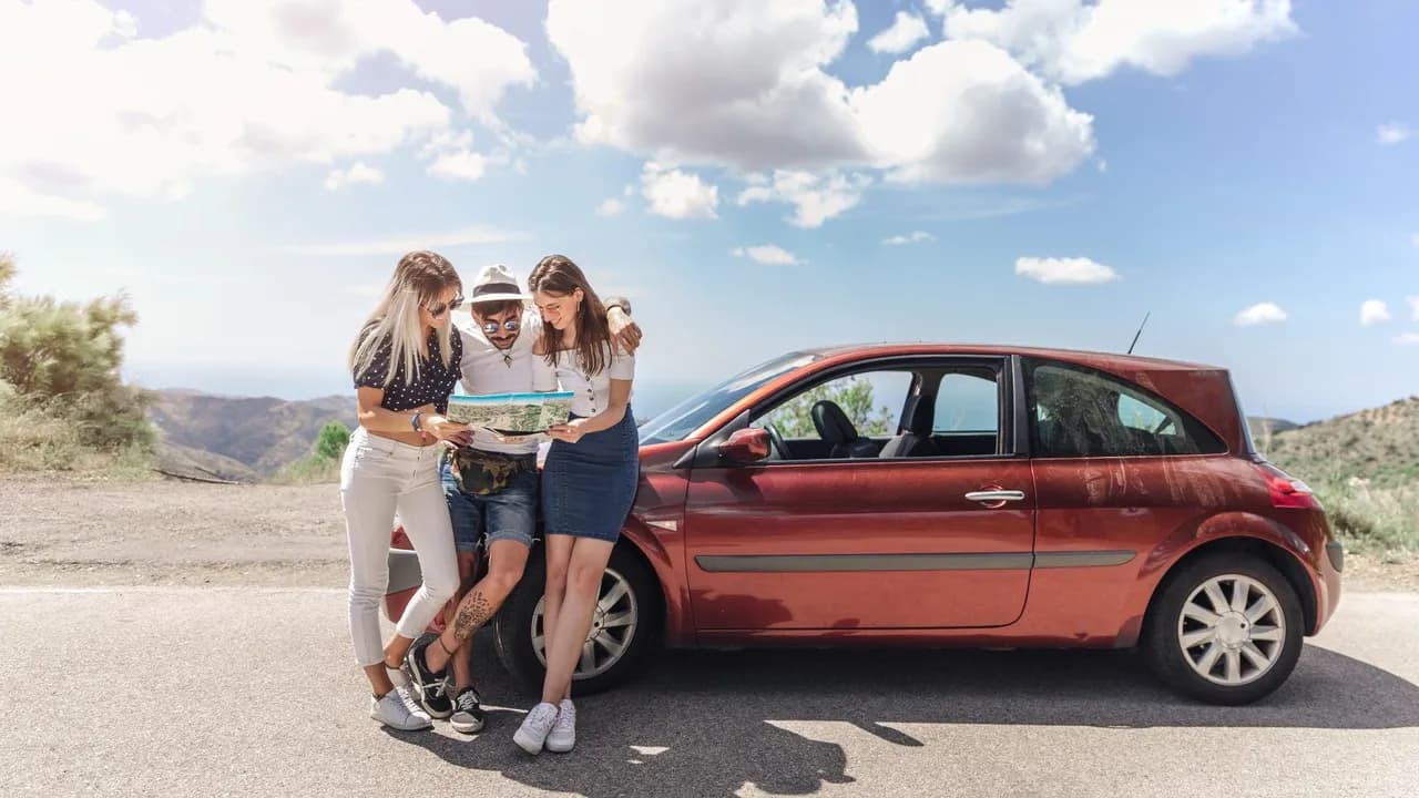 photologuephotos2022-12three-friends-looking-at-map-standing-near-the-modern-car-on-roadjpg photologuephotos2022-12three-friends-looking-at-map-standing-near-the-modern-car-on-roadjpg